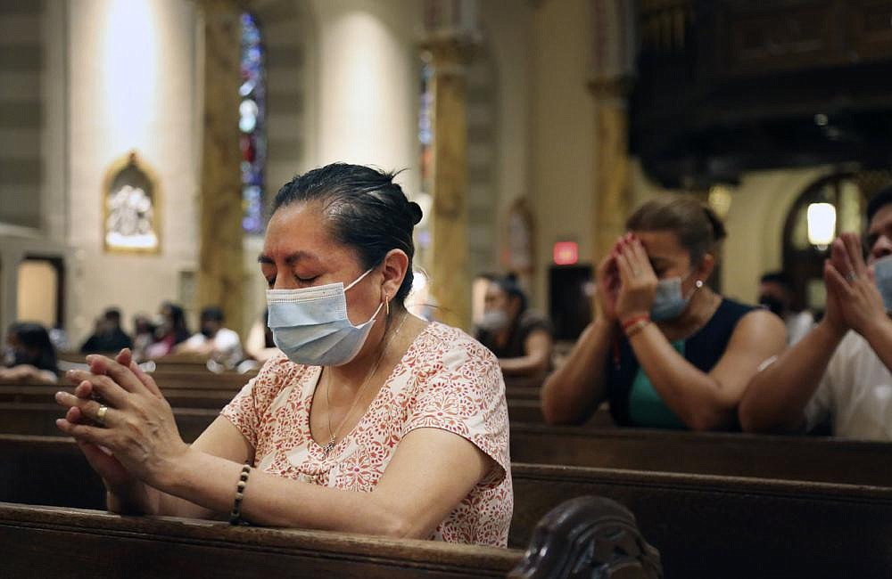 Claudia Balderas, 51, prays for her brother, who died from covid-19 in May, on Monday, while attending the fi rst in-person Mass in almost four months at the Queens, N.Y., Saint Bartholomew Roman Catholic Church.
(AP/Jessie Wardarski)
