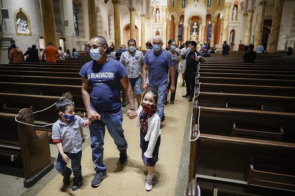 Parishioners leave at the end of a Spanish-language Mass at Saint Bartholomew Roman Catholic Church in the Queens borough of New York.
(AP/John Minchillo)