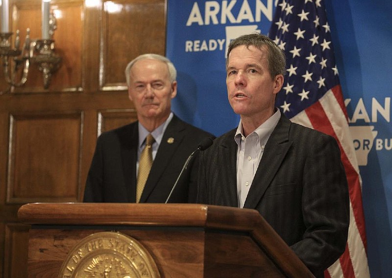 Dr. Cam Patterson, right, chancellor of the University of Arkansas for Medical Sciences, along with Gov. Asa Hutchinson speaks Friday May 8 during the daily COVID-19 briefing at the state Capitol in Little Rock. (Staton Breidenthal/Arkansas Democrat-Gazette)