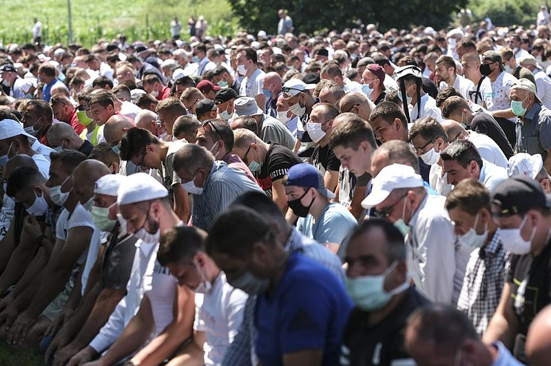 Bosnians pray Saturday in Potocari, near Srebrenica, marking the 25th anniversary of the 1995 massacre of thousands of people there. More photos at arkansasonline.com/712bosnia/ (AP/Kemal Softic) 
