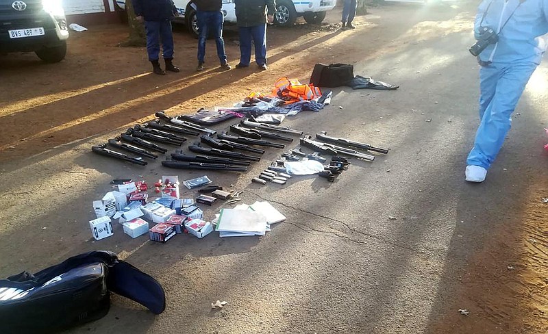 Firearms and ammunition confiscated after the hostage-taking lie Saturday outside a church in Zuurbekom, in this photo provided by the South African Police Services. (AP) 