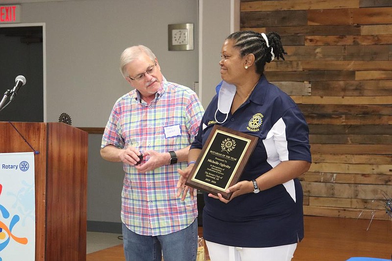 John Carter looks on while incoming president Michelle Oglesby (right) shows her Rotarian of the Year award at the installation of officers of the Rotary Club of Sherwood, also a dinner that took place June 23, 2020, at Sherwood Forest.
(Arkansas Democrat-Gazette -- Helaine R. Williams)