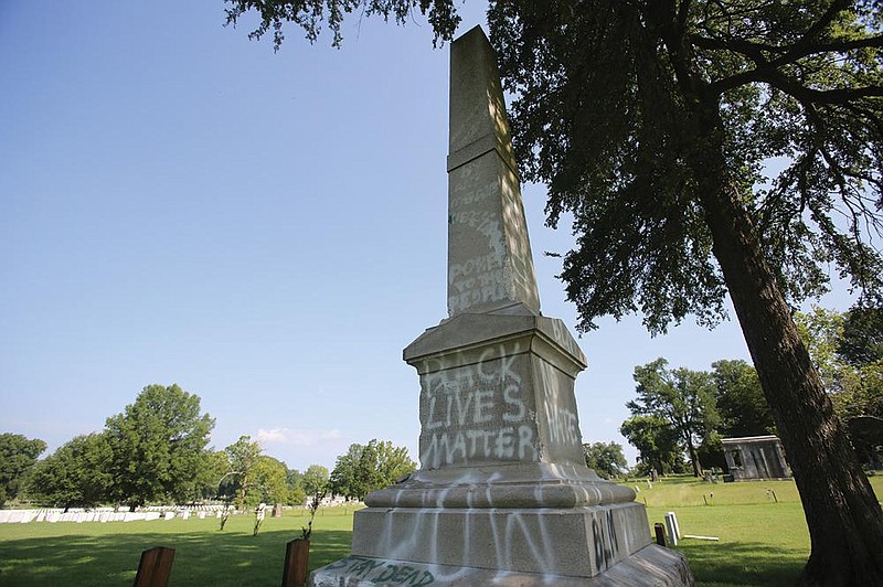 Vandals sprayed paint on the Confederate monument early Thursday in the Oakland Cemetery in Little Rock.
(Arkansas Democrat-Gazette/Thomas Metthe)