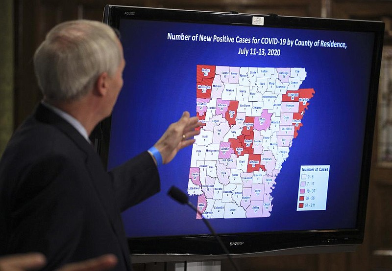 Gov. Asa Hutchinson goes over the latest data Monday during his coronavirus briefing at the state Capitol in Little Rock. More photos at arkansasonline.com/714governor/. (Arkansas Democrat-Gazette/Staton Breidenthal) 