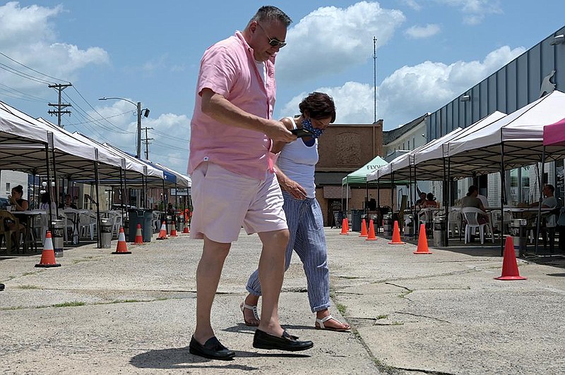 Terry Gibson and Flara Hobbs are shown Saturday at Flyway Brewing in North Little Rock. A proposed mask ordinance will be pre- sented to the City Council today. (Arkansas Democrat-Gazette / Stephen Swofford) 

