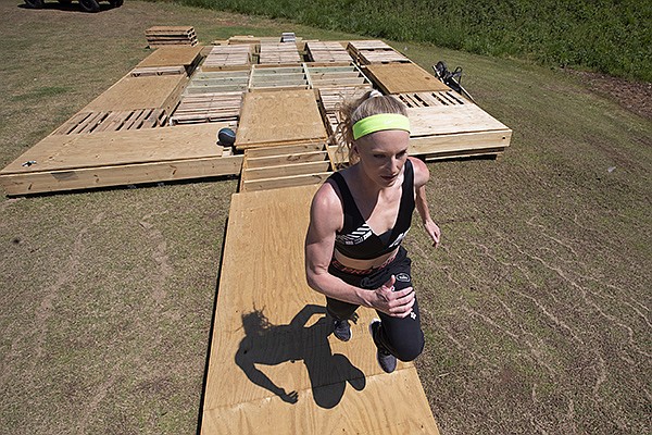 Olympic pole vaulting silver medalist Sandi Morris runs on vaulting pit she is building with her father in Greenville, S.C., Tuesday, April 14, 2020. (AP Photo/John Bazemore)