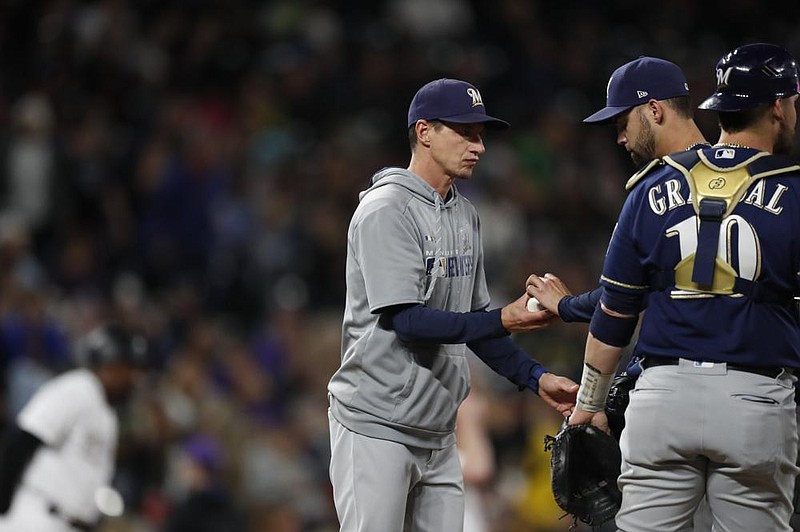 Milwaukee Brewers Manager Craig Counsell (left) will have several intrasquad scrimmages as the Brewers try to simulate the inten- sity of a real game in the lead up to the regular season. (AP/David Zalubowski) 
