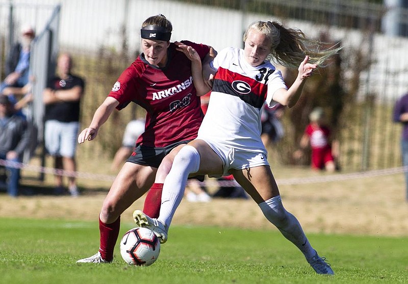 Arkansas’ Haley VanFossen (left) fights for the ball with Georgia’s Reagan Glisson in a 2019 game. The Razorbacks will lose six soccer matches as a result of the SEC’s decision to delay the start of the season for three fall sports. 
(Special to NWA Democrat-Gazette/David Beach) 
