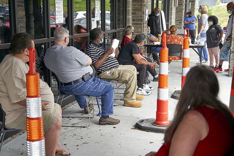 Job seekers exercise social distancing as they wait to be called into the Heartland Workforce Solutions office in Omaha, Neb., Wednesday, July 15, 2020.