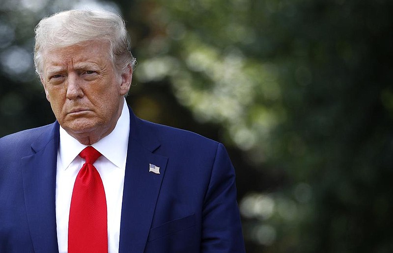 President Donald Trump approaches reporters Wednesday on the South Lawn of the White House before flying to Atlanta. Trump chided trade adviser Peter Navarro for criticizing Dr. Anthony Fauci, saying that “we’re all on the same team.” More photos at arkansasonline.com/716covid.
(AP/Patrick Semansky)