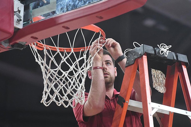 Fixing a net is just one of the things that video coordinator Riley Hall does to help the Arkansas men’s basketball team that goes beyond his job description.
(NWA Democrat-Gazette/J.T. Wampler)