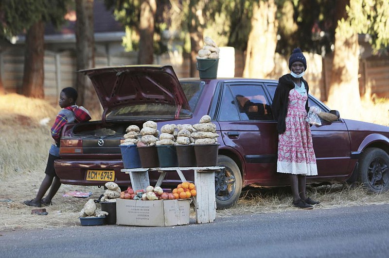 Fruits and vegetables await buyers Tuesday on the side of a busy road in Harare, Zimbabwe, as jobless workers try to meet their financial needs. More photos at arkansasonline.com/716car/.
(AP/Tsvangirayi Mukwazhi)