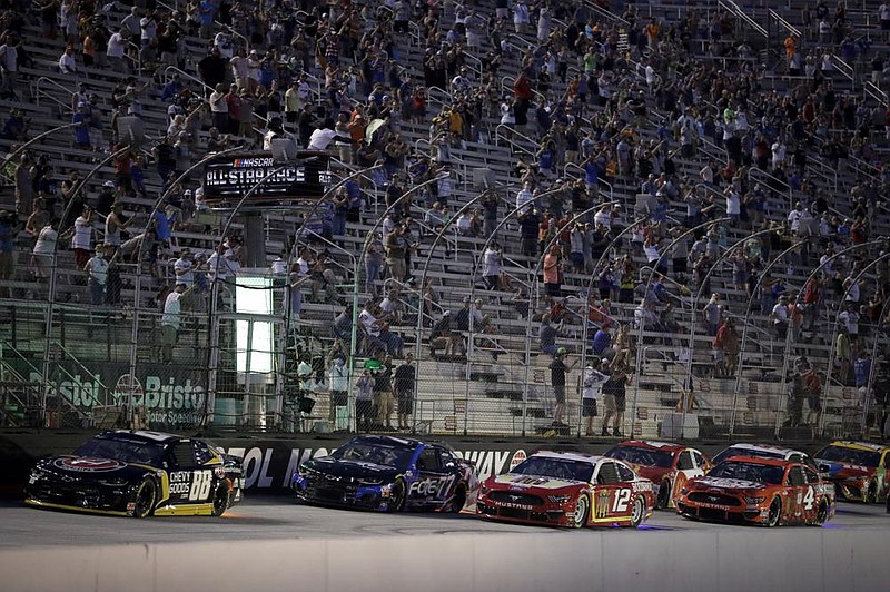 Cars run during  the NASCAR Cup Series All-Star Race on  Wednesday at Bristol, Tenn. The track was allowed to sell up to 30,000 tickets for the race and Texas Motor Speedway has been allowed to admit up to 67,500 spectators for Sunday’s race. Iowa  Speedway, which is owned by NASCAR, will allow up to 60,000 fans for this weekend’s IndyCar race.
(AP/Mark Humphrey)