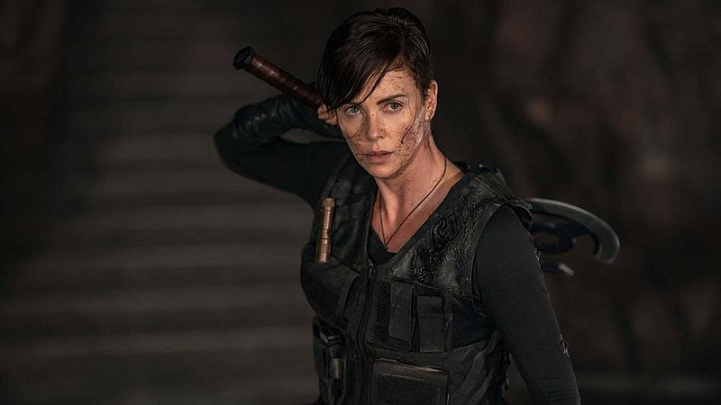 Charlize Theron is Andy, also known as Andromache of Scythia, a centuries old warriors with regenerative healing abilities who uses her vast experience — and her ax — to help people in the Netflix movie “The Old Guard.”