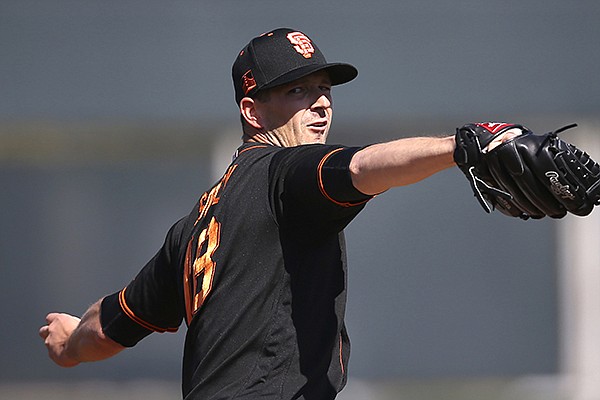 San Francisco Giants starting pitcher Drew Smyly warms up during the second inning of a spring training baseball game against the Arizona Diamondbacks Monday, Feb. 24, 2020, in Scottsdale, Ariz. (AP Photo/Ross D. Franklin)