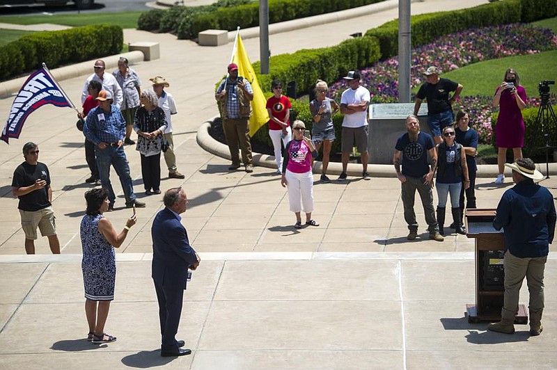 Protesters came to the steps in front of the Arkansas State Capitol to protest recent mask mandates on Monday, July 21. Attendees listen to farmers and state representatives speak during a the protest. (Arkansas Democrat-Gazette/Stephen Swofford)