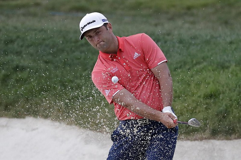Jon Rahm, of Spain, hits from a bunker toward the 14th green during the final round of the Memorial golf tournament, Sunday, July 19, 2020, in Dublin, Ohio. (AP Photo/Darron Cummings)