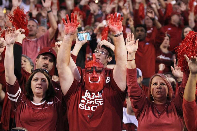 Arkansas football fans call the Hogs during a game at Fayetteville in 2016. On July 26, 2013, the UA led for a registered trademark for the “Woooo! Pig Sooie!” cheer. (AP file photo) 
