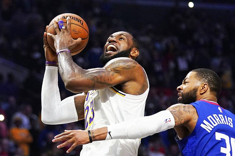 LeBron James (left) and the Los Angeles Lakers are squarely in the mix to compete for a champi- onship when the NBA season resumes. It’s a rare bit of normalcy for a player who appeared in eight consecutive NBA Finals in 2011-2018 and for a franchise that has won 16 championships. (AP file photo) 