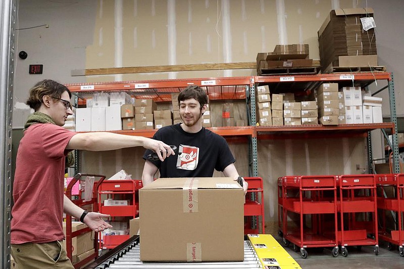 Target employees in Edison, N.J., sort online orders for shipping in this file photo. Demand for delivery has grown as people avoid visiting stores and restaurants during the pandemic. (AP) 