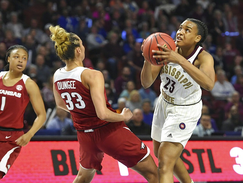 Bre'Amber Scott (23), then of Mississippi State, drives against Arkansas' Chelsea Dungee (33) during the first half of an NCAA college basketball championship game in the Southeastern Conference women's tournament in Greenville, S.C., in this March 10, 2019, file photo. Scott, a graduate of Little Rock Central High School, transferred to the University of Arkansas at Little Rock in the spring and has been cleared to play for the team in the 2020-21 season.