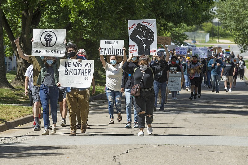 Protesters march Wednesday, June 10, 2020, on North 3rd Street during a Black Lives Matter protest in Rogers. The march began at the Rogers Activity Center and ended at Rogers city hall. 
(NWA Democrat-Gazette/Ben Goff)
