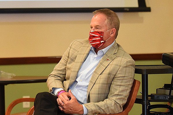 Arkansas athletics director Hunter Yurachek listens to Gov. Asa Hutchinson speak Wednesday, July 22, 2020, during his daily covid-19 briefing at the Center for Exercise on the campus of Washington Regional Medical Center in Fayetteville.