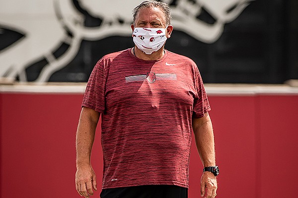 Arkansas coach Sam Pittman watches players during a July 2020 workout in Fayetteville.
