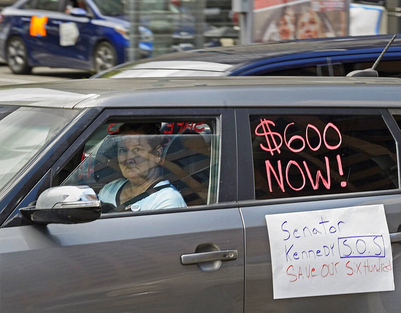 Motorists take part in a caravan protest in front of the office of U.S. Sen. John Kennedy, R-La., at the Hale Boggs Federal Building in New Orleans on Wednesday, July 22, 2020. The motorists were asking for the extension of the $600 in unemployment benefits to people out of work because of the coronavirus.