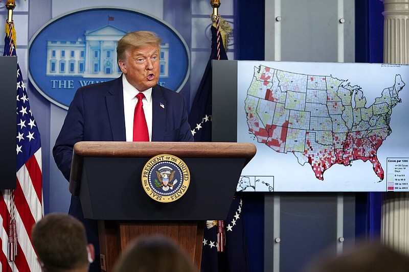 President Donald Trump speaks during a news conference at the White House in Washington on Thursday, July 23, 2020. At right is a chart of coronavirus cases around the United States.