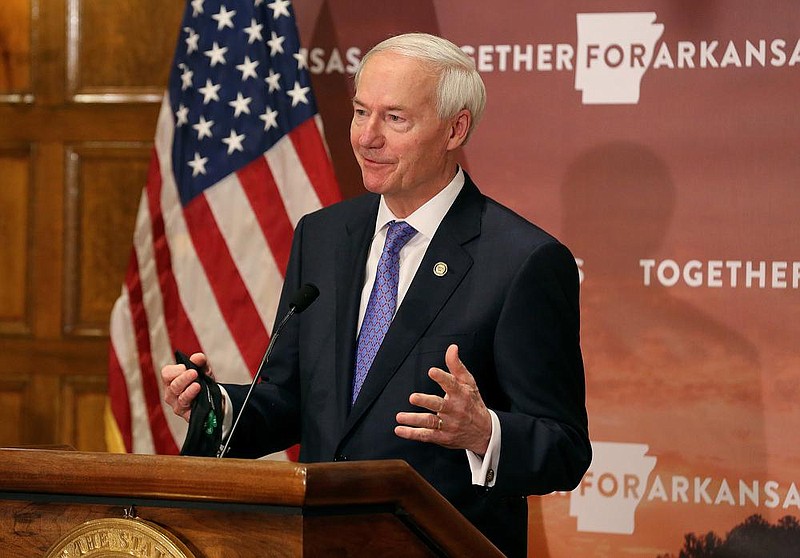 Mask in hand, Governor Asa Hutchinson answers a question during the daily COVID-19 briefing on Thursday, July 23, at the state Capitol in Little Rock. (Arkansas Democrat-Gazette/Thomas Metthe)