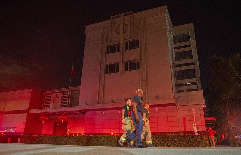 Houston firefighters respond Tuesday night to reports of papers being burned on the grounds of the Chinese consulate. They were not allowed inside. More photos at arkansasonline.com/723houston/.
(AP/Houston Chronicle/Mark Mulligan)