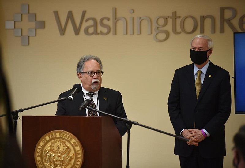 Interim Health Secretary Jose Romero (left) said Wednesday in Fayetteville that while children under age 10 have “not been shown to be very effective in spreading the virus,” older children “may be more capable of spreading it.”
(NWA Democrat-Gazette/David Gottschalk)