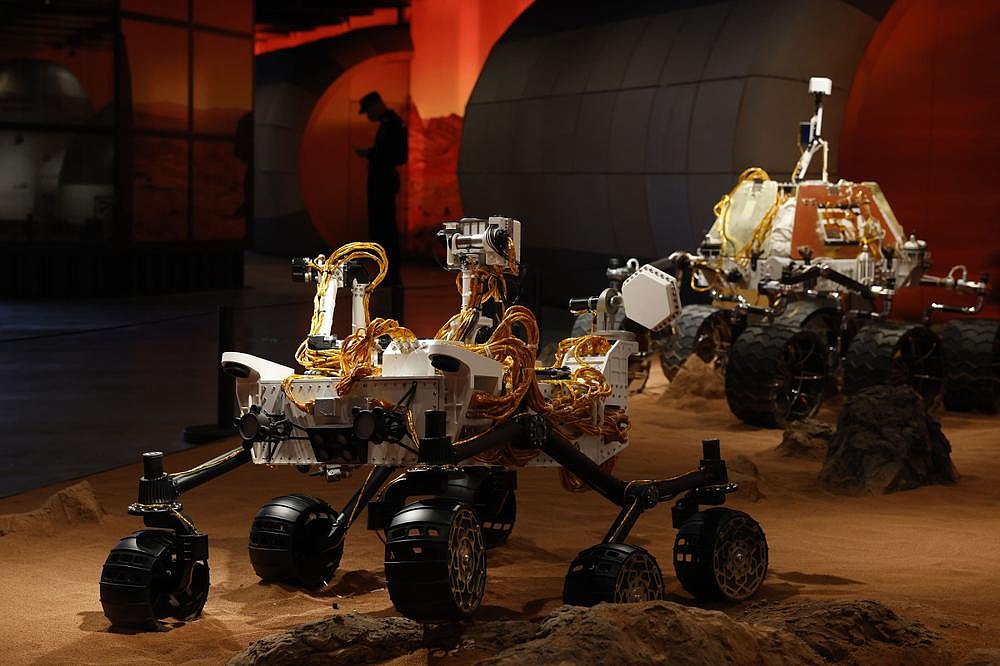 A display depicts rovers on Mars at an exhibition in Beijing on Thursday as China launched its Mars mission. “There is a whole lot of prestige riding on this,” said Dean Cheng, an expert on Chinese aerospace programs at the Heritage Foundation in Washington. (AP/Ng Han Guan)