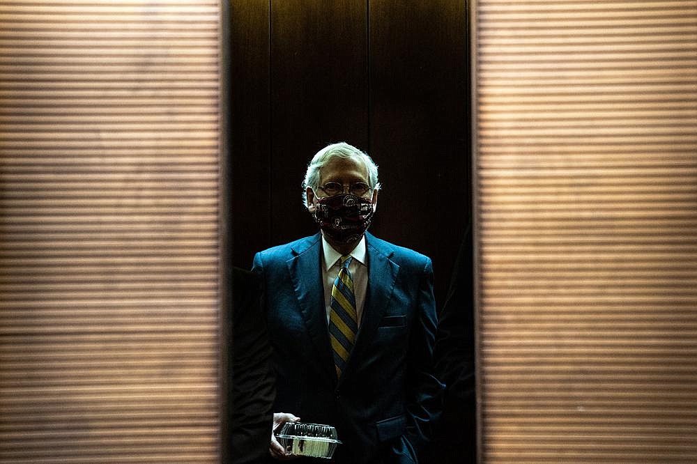 Senate Majority Leader Mitch McConnell rides an elevator after a GOP luncheon Thursday. “This terrible virus is still with us. It kills more Americans every day,” he said as stimulus bill negotiations wore on.
(The New York Times/Anna Moneymaker)