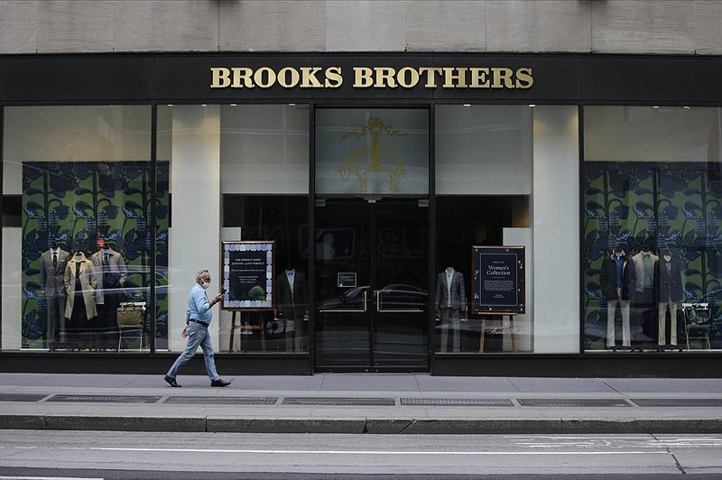 A pedestrian passes a Brooks Brothers store in New York. The clothier filed for bankruptcy earlier this month.
(AP/Frank Franklin II)