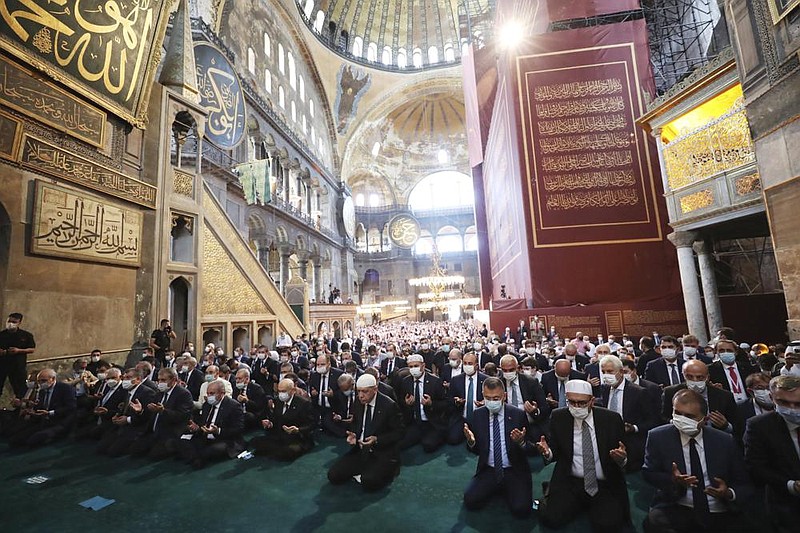 Turkish President Recep Tayyip Erdogan (center) on Friday takes part in the first Muslim prayers in 86 years at the historic Hagia Sophia in Istanbul. More photos are available at arkansasonline.com/725turkey/
(AP/Turkish Presidency)