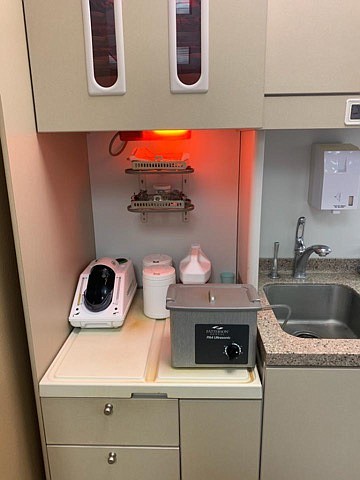 Keeping things clean: This red light is where non-sterilized or recently used instruments are placed. They first go in this ultrasonic cleaner. Any yellow on the counter in this picture is due to the chemicals. (Contributed)