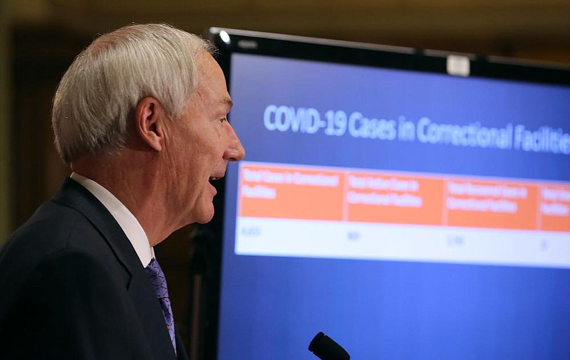 Gov. Asa Hutchinson gives a breakdown of COVID-19 cases in the state prisons during the daily COVID-19 briefing on Thursday, July 24, at the state Capitol in Little Rock. (Arkansas Democrat-Gazette/Thomas Metthe) story.lead_photo.caption