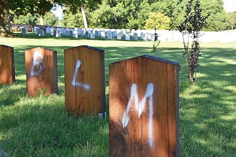 Defaced headstones sit around the Confederate monument on Friday, July 26, 2020 at Oakland Cemetery in Little Rock. (Arkansas Democrat-Gazette/Staci Vandagriff)
