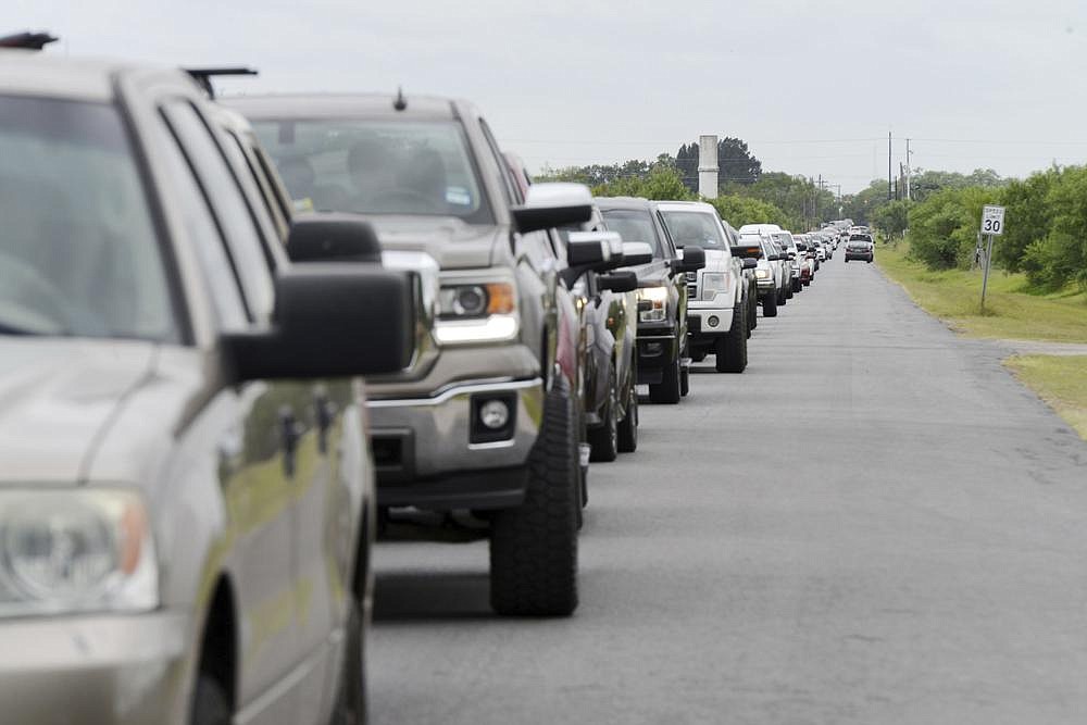 Hundreds of motorists wait in line for sandbags in Brownsville, Texas, to get ready for expected torrential rainfall from Hurricane Hanna, which swept ashore Saturday as a Category 1 storm.
(AP/The Brownsville Herald/Miguel Roberts)