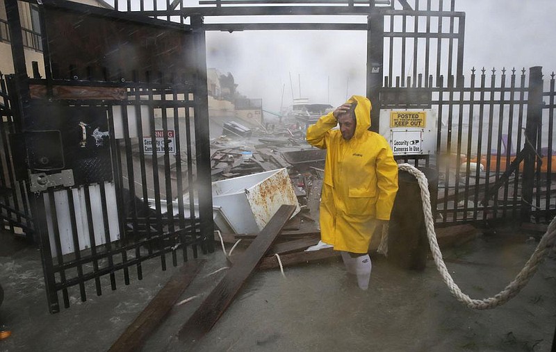 Jame Rowles examines the damage Saturday in Corpus Christi, Texas, after the docks at the marina where his boat was secured were destroyed as Hurricane Hanna made landfall. More photos at arkansasonline.com/726hanna/.
(AP/Eric Gay)