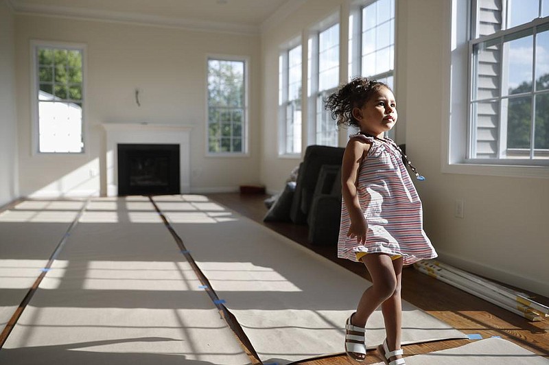 Paige Lilly plays in her new home earlier this month in Washingtonville, N.Y. (AP/John Minchillo) 
