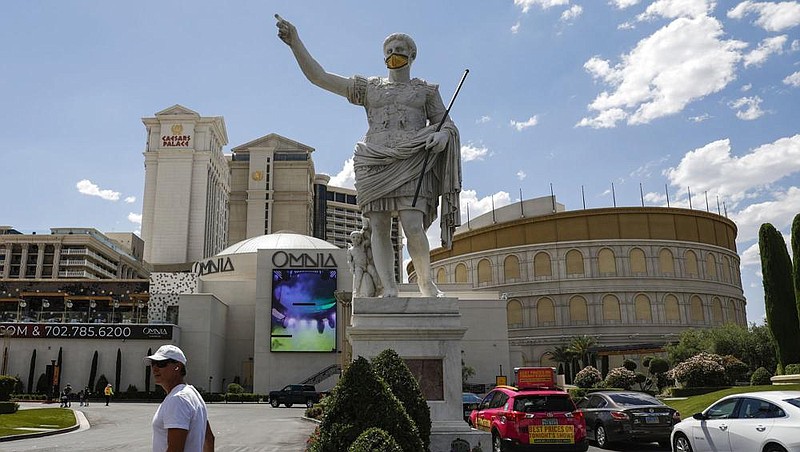 A pedestrian walks in front of Caesars Entertainment Corp.’s Caesars Palace hotel in Las Vegas last month. (Bloomberg News/Joe Buglewicz) 