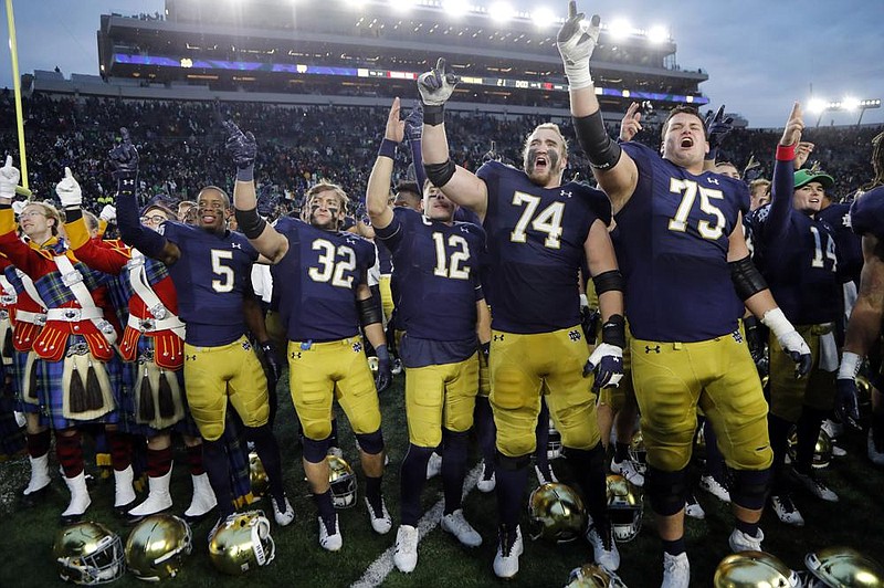 Members of the Notre Dame football team sing after a 2019 game against Virginia Tech. The Atlantic Coast Conference and Notre Dame are considering whether the Fighting Irish will give up their status as an independent for the 2020 season to play as a member of the league.
(AP file photo)