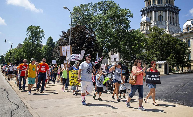 Michael Rebresh, an organizer of a “Million Unmasked March,” leads protesters toward the Illinois State Board of Education at the state Capitol in Springfield on Saturday. The marchers gathered in front of a statue of Abraham Lincoln to express opposition to guidelines that children be required to wear masks when they return to school.
(AP/The State Journal-Register/Justin L. Fowler)