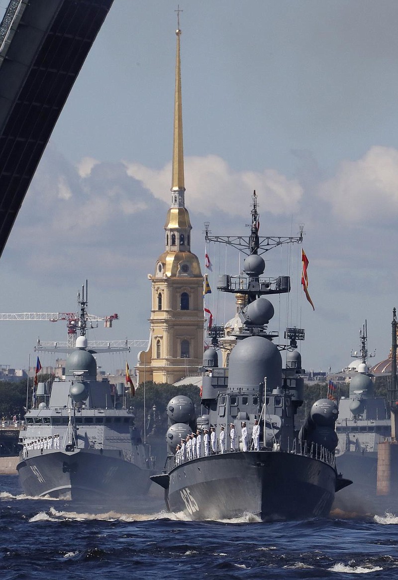 Warships wake way past a drawbridge rising above the Neva River during the Navy Day parade in St.Petersburg, Russia, Sunday, July 26, 2020.(AP Photo/Anatoly Maltsev, Pool)