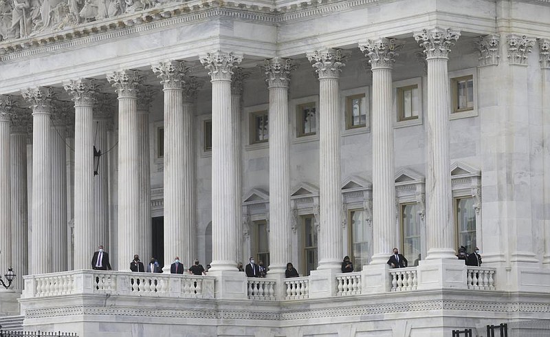 Members of Congress and their staffs watch Monday as the hearse carrying the ag-draped casket of Rep. John Lewis, D-Ga., arrives at the U.S. Capitol. More photos at arkansasonline.com/728capitol/. (AP/Leah Millis) 

