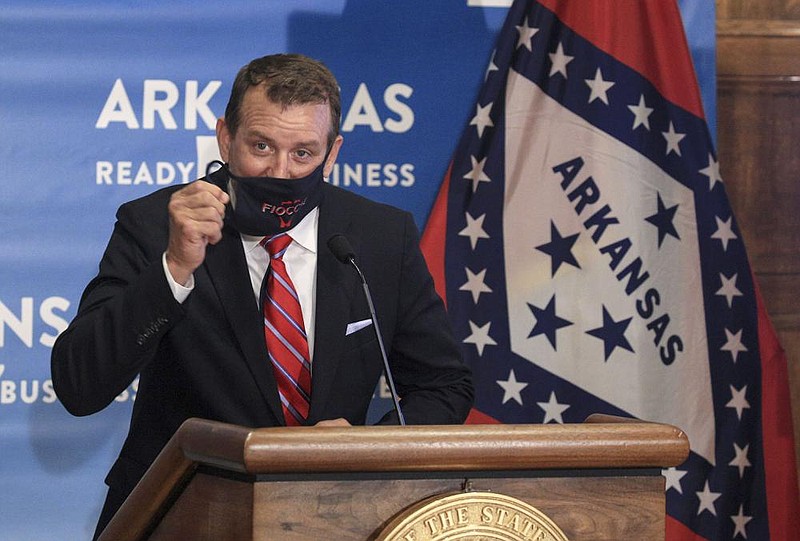 Anthony Acitelle, CEO of Fiocchi America, takes off his mask Wednesday before speaking during a news conference at the Capitol where the governor announced Fiocchi’s plans to add jobs at its Little Rock facility.
(Arkansas Democrat-Gazette/Staton Breidenthal)