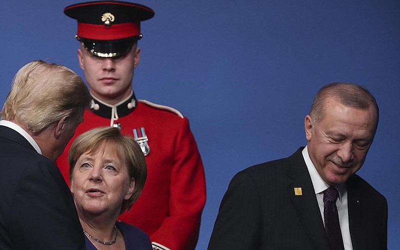 President Donald Trump talks with German Chancellor Angela Merkel and Turkish President Recep Tayyip Erdogan at a NATO leaders meeting in Great Britain in early December. The Pentagon announced plans Wednesday to move troops out of Germany, citing Germany’s lagging defense spending.
(AP/Francisco Seco)